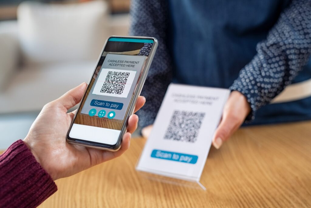 customer hand scanning qr code with phone for digi kj8np5y scaled